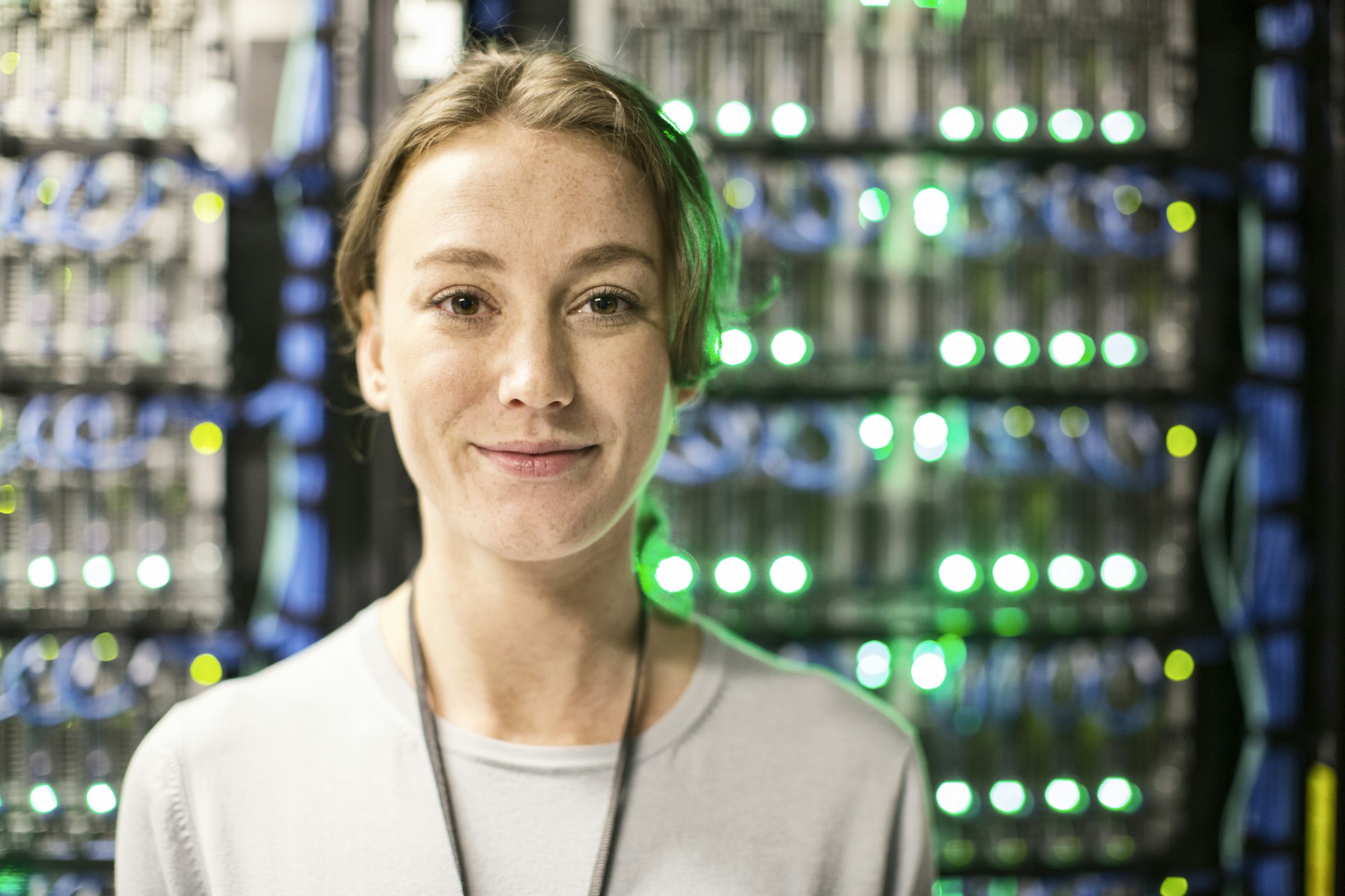 Caucasian woman technician in a large computer server farm.